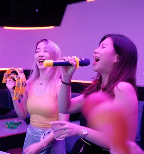 group of people singing karaoke at HaveFun Karaoke in Singapore